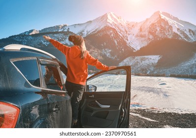 Woman traveling in car, exploring, enjoying the view of the winter mountains landscape. - Powered by Shutterstock