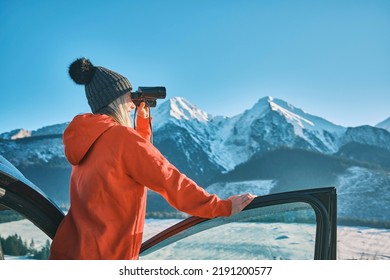 Woman traveling exploring, enjoying the view of the mountains, landscape, lifestyle concept winter vacation outdoors.
Female standing near the car in sunny day, Girl looking through binoculars, travel - Shutterstock ID 2191200577