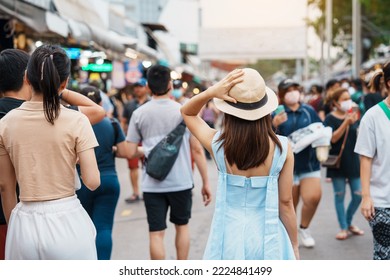 woman traveling with hat, Asian traveler standing at Chatuchak Weekend Market, landmark and popular for tourist attractions in Bangkok, Thailand. Travel in Southeast Asia concept