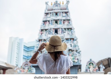 Woman Traveling With White Dress And Hat, Happy Asian Traveler Looking To Sri Mariamman Temple In Chinatown Of Singapore. Landmark And Popular For Tourist Attractions. Southeast Asia Travel Concept