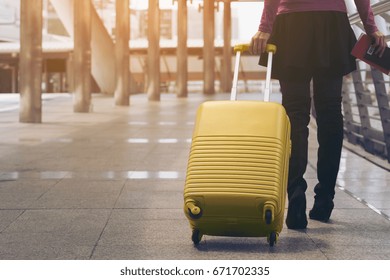 Woman Traveller With Travel Bag Or Luggage Walking In Airport Terminal Walkway For Travel Abroad.