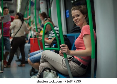 Woman travels overground metro in the afternoon in Madrid