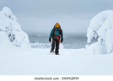 Woman Trekking Through A Snow Covered Lapland, Finland