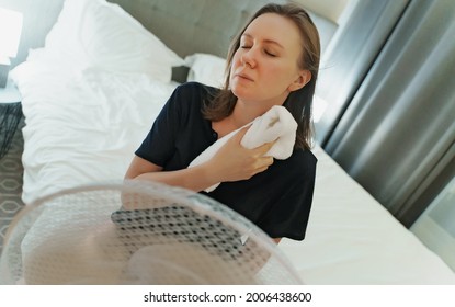 Woman Tries To Cool Off During The Intense Heat In Front Of Cooling Fan.