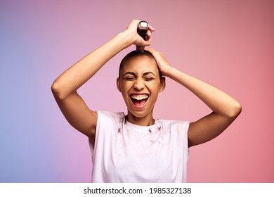 Woman Trimming Her Head To Bald On Multicolored Background. Female Shaving Off Her Hair With Hair Clippers.