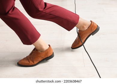 Woman Tripping Over Cable In Office, Closeup