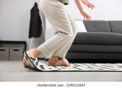 Woman Tripping Over Carpet At Home, Closeup