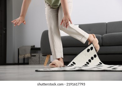 Woman Tripping Over Carpet At Home, Closeup