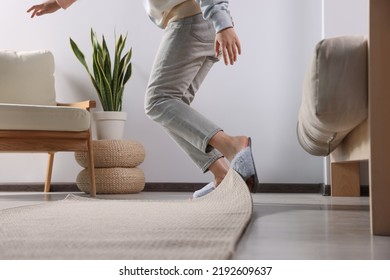 Woman Tripping Over Carpet At Home, Closeup