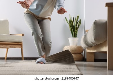 Woman Tripping Over Carpet At Home, Closeup