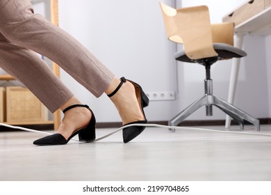 Woman Tripping Over Cord In Office, Closeup. Space For Text