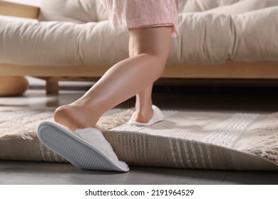 Woman Tripping Over Rug At Home, Closeup