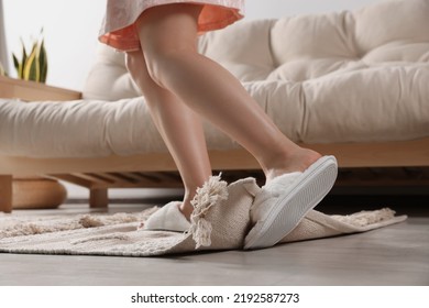 Woman Tripping Over Rug At Home, Closeup