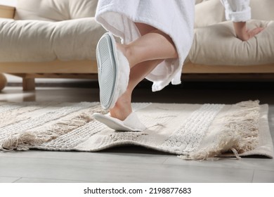 Woman Tripping Over Rug At Home, Closeup