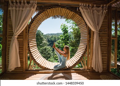 Woman in tropical open yoga studio place a view outside to the hills while sunset.Girl in eco hotel panoramic windows enjoying solitude with nature on Bali island - Powered by Shutterstock