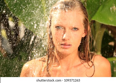 woman in tropical shower with palm and banana trees - Shutterstock ID 109371263