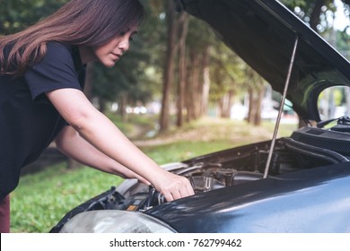 Woman Try To Fixing Broken Old Car With Outdoor Background