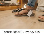 Woman trying comfortable leather sandals in a shoe store