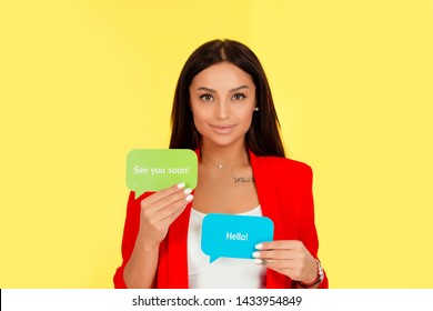 Woman Trying To Communicate In English Holding Speak Text Bubble Paper With Elementary Words: Hello, See You Soon On Them. Mute Communication Through Text, Translation, New Language Learning Concept