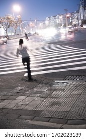 Woman Trying To Cross Street In Asian City At Night