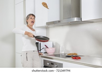 Woman Trying To Flip A Pancake For The First Time And Get Scared To Throw It On The Floor