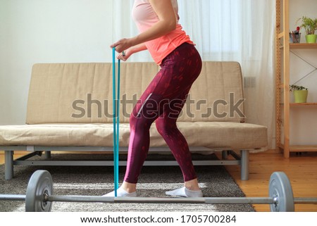 A woman trying to lose weight at home with training. Home trainig concept