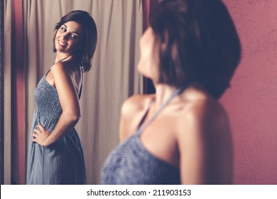 Woman Trying On Clothes In A Clothing Store