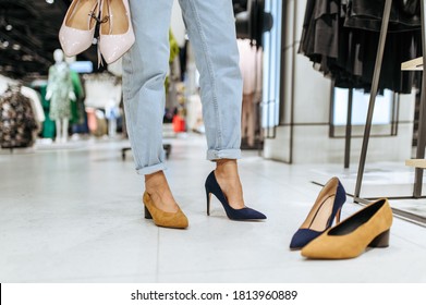 Woman Trying On Shoes In Store, View On Feets