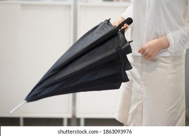 Woman Trying To Open Umbrella