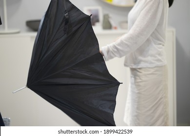 Woman Trying To Open Umbrella
