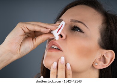 Woman Trying To Stop Blood Bleeding From Nose