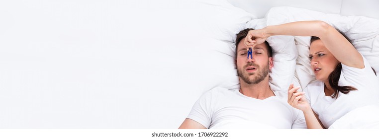 Woman Trying To Stop Snoring And Sleep Apnea Of Man