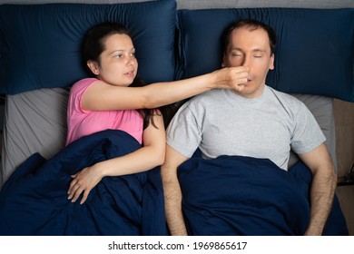 Woman Trying To Stop Snoring And Sleep Apnea Of Man