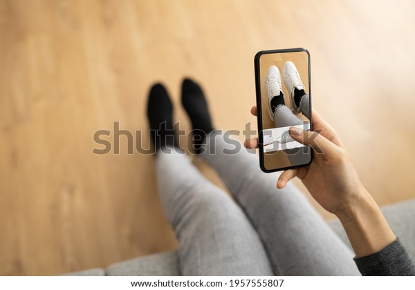 Woman\
Trying Virtual Sneakers In Shop Or Store AR\
App