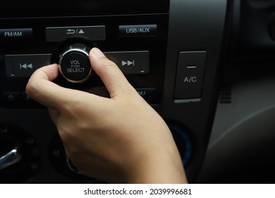 Woman Tuning In Car Music While Driving