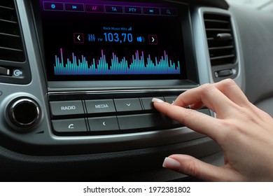 Woman Tuning Into A Radio Station In Car