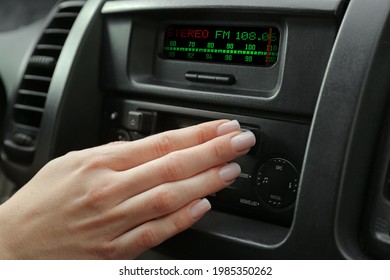 Woman Tuning Into A Radio Station In Car