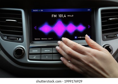 Woman Tuning Into A Radio Station In Car