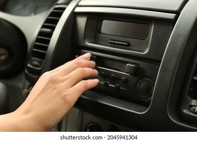 Woman Tuning Radio In Car, Closeup