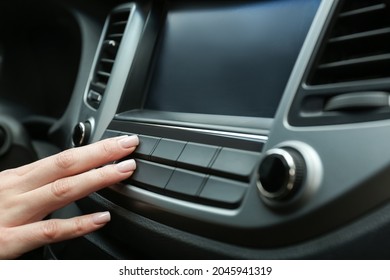 Woman Tuning Radio In Car, Closeup