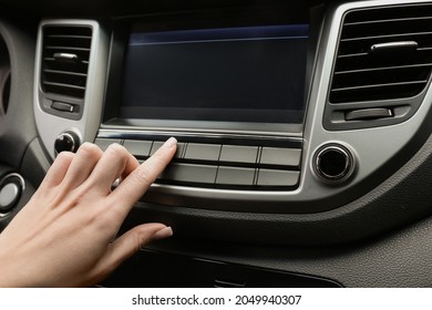 Woman Tuning Radio In Car, Closeup