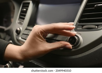 Woman Tuning Radio In Car, Closeup