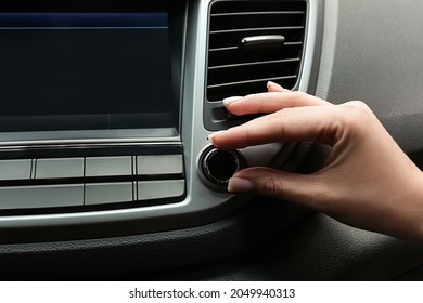 Woman Tuning Radio In Car, Closeup