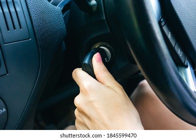 Woman Is Turning Ignition Key In The Car. Girl Is Driving.