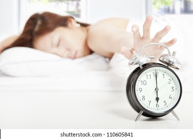 Woman Turning Off The Alarm Clock