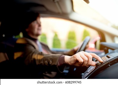 Woman Turning On Radio Driving Home In A Car.