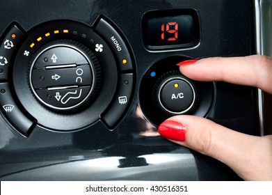 Woman Turns On Air Conditioning In A Car