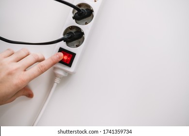 A Woman Turns On An Electric Surge Protector. Protection Of Household Appliances From Electrical Interference. Home Safety. Flat Lay