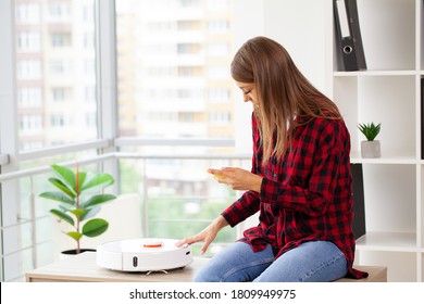 Woman Turns On Smart Robot Vacuum Cleaner