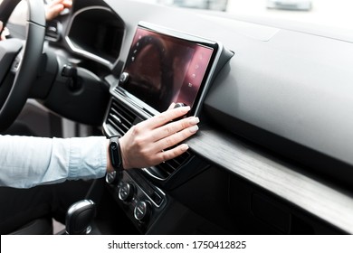 Woman Twists The Controls On The Car Radio. Listening To The Radio In The Car